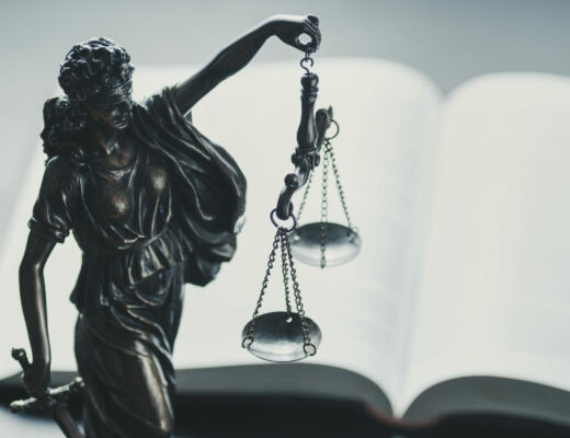 Silver figure of Justice holding scales